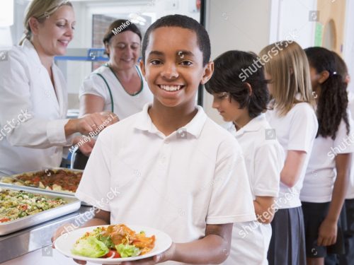 stock-photo-students-in-cafeteria-line-with-one-holding-his-healthy-meal-and-looking-at-camera-76861786